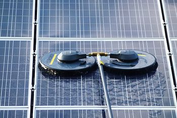 Cleaning a photovoltaic system with rotating brushes